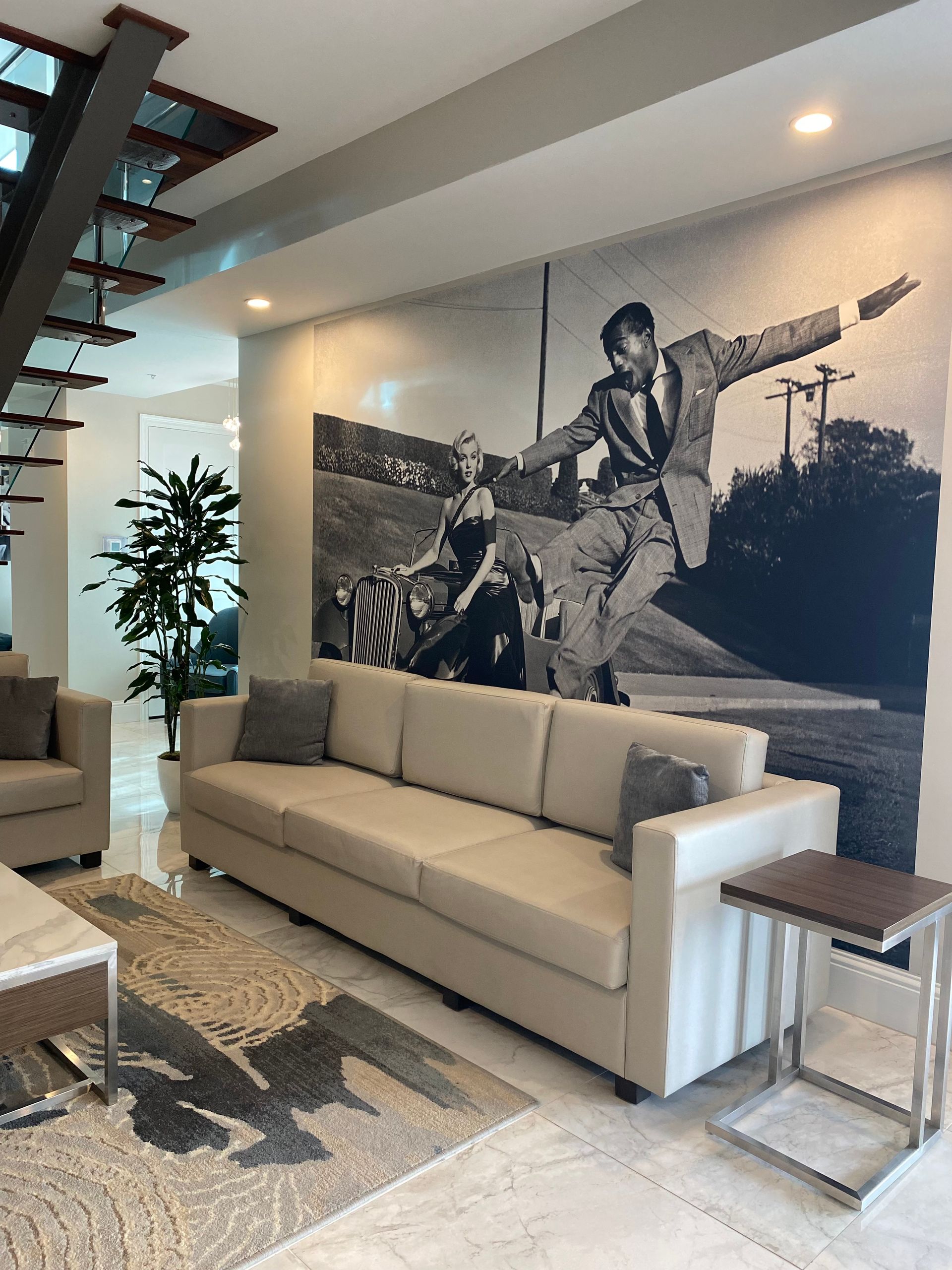 A living room with a couch and a picture on the wall