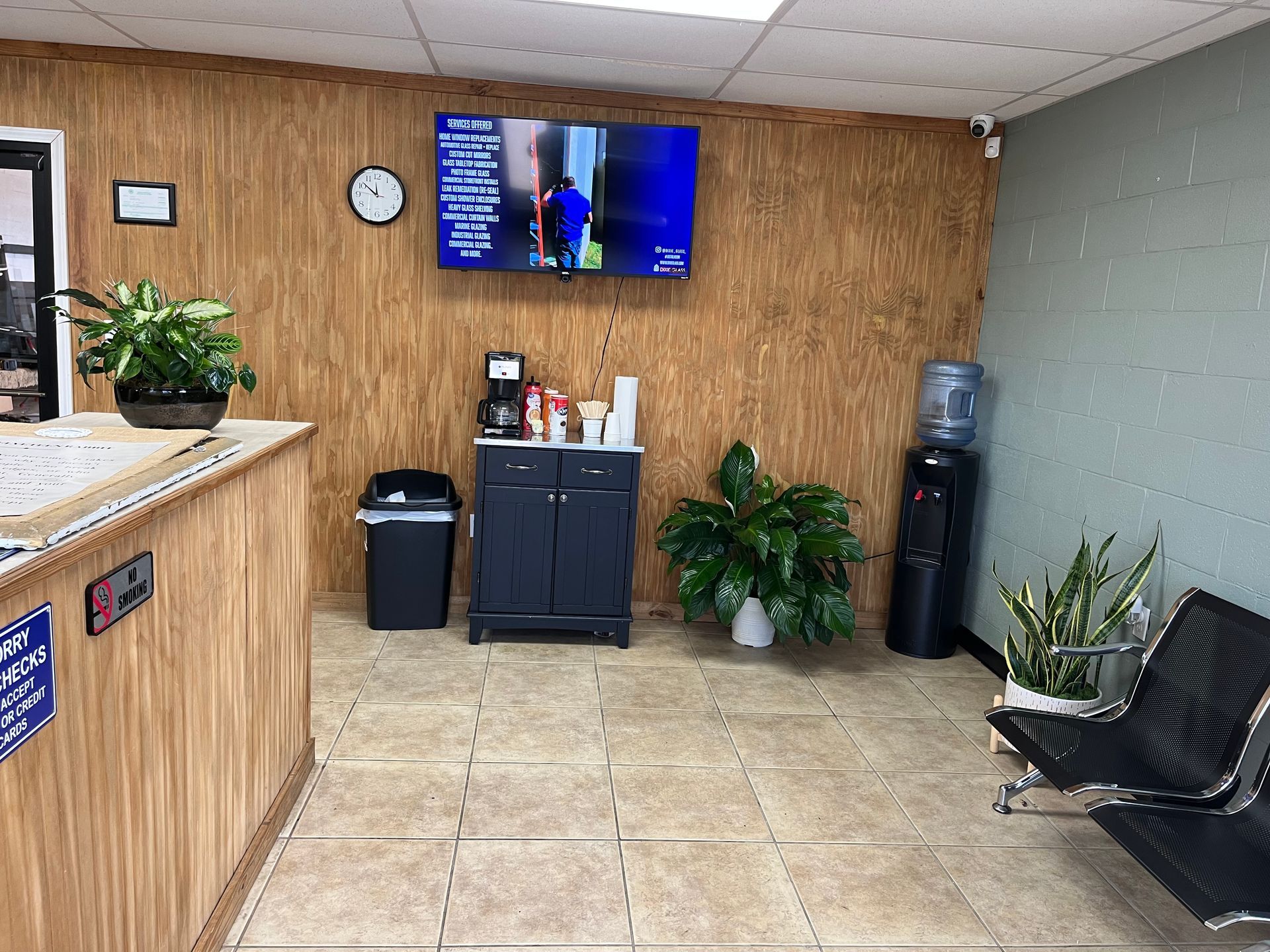 A waiting room with a tv on the wall.
