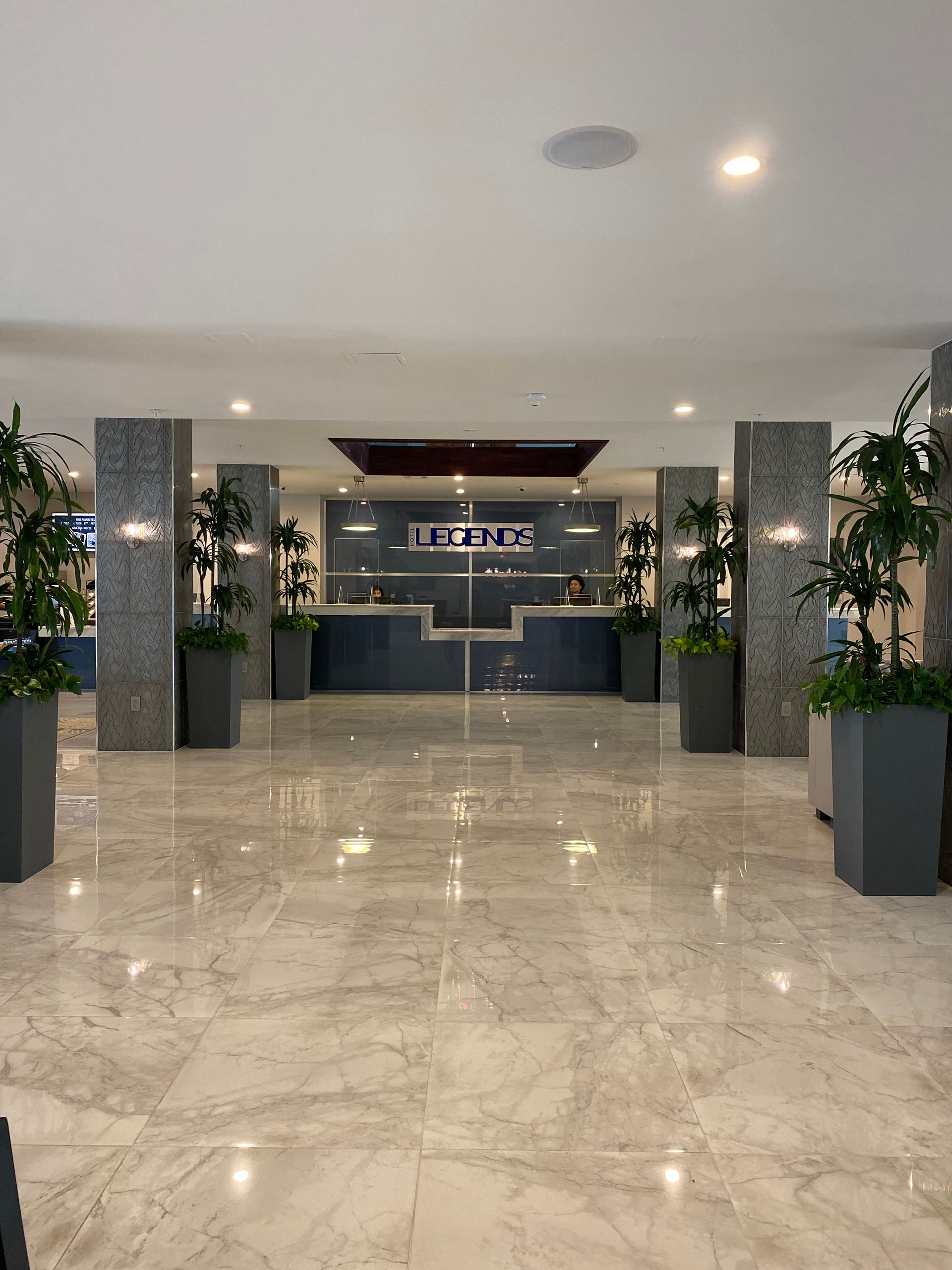 A lobby of a hotel with a sign 