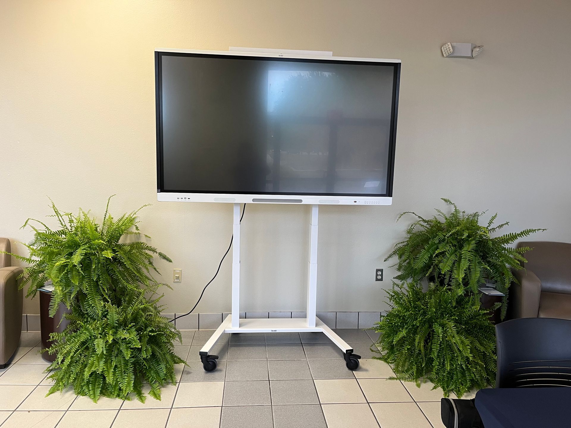 A large flat screen tv on a stand in a room