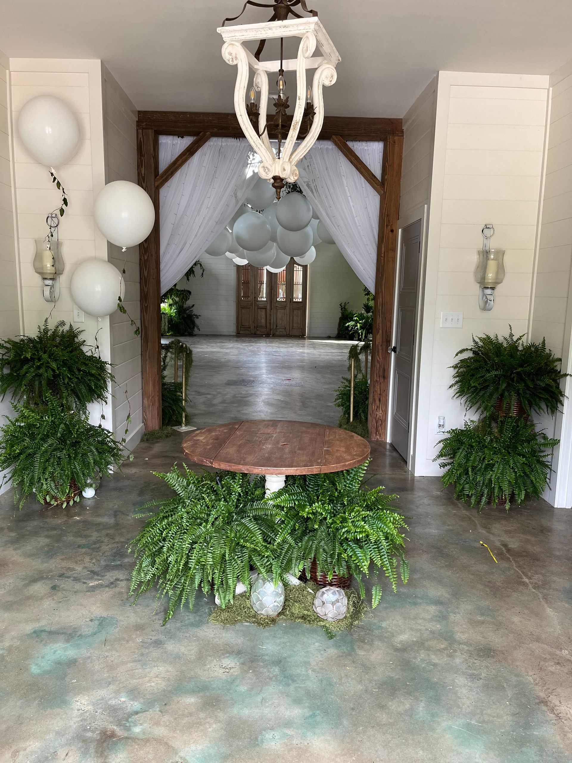 A room with a table and balloons in it