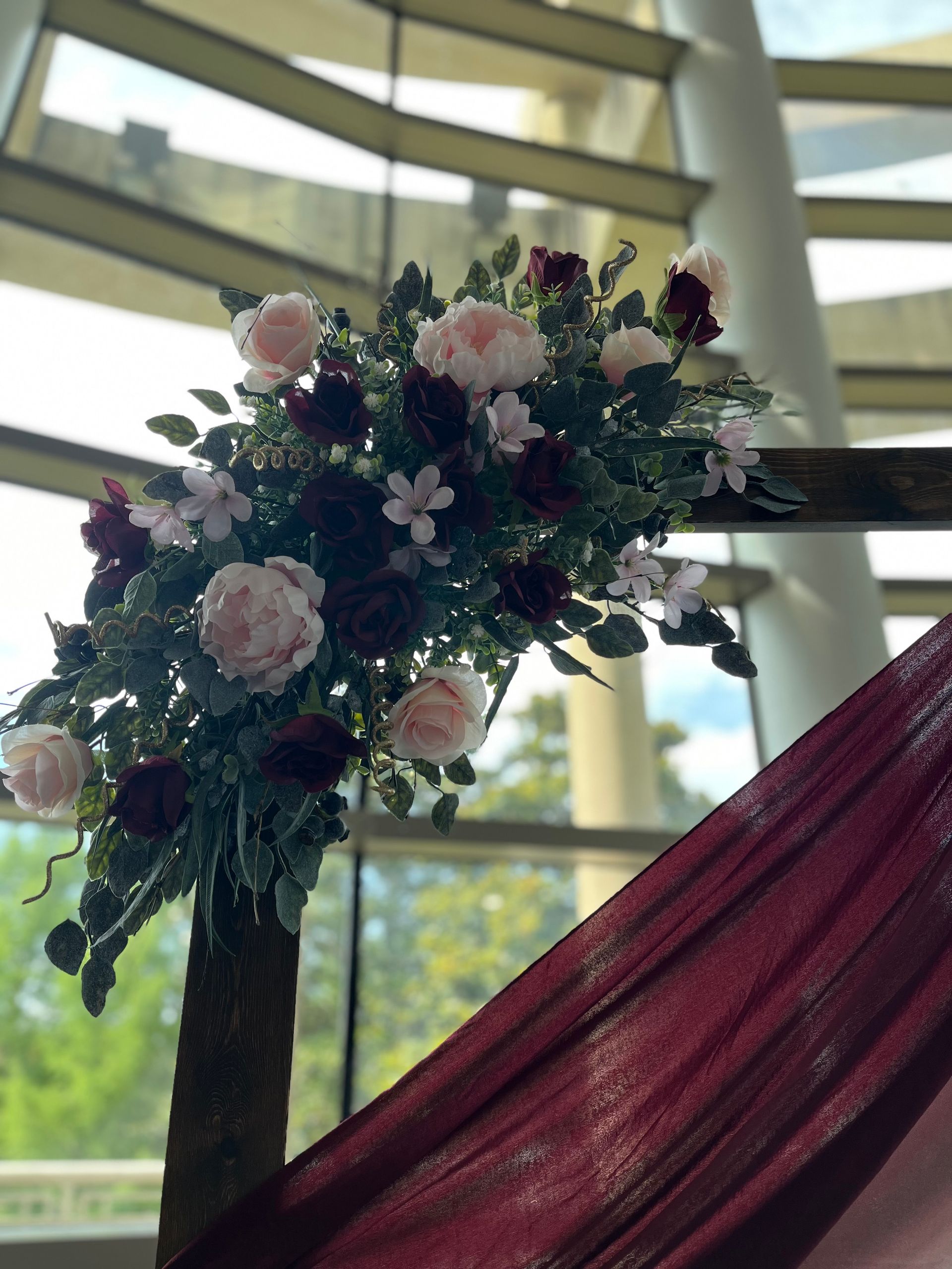 A bunch of flowers are sitting on a table in front of a window.