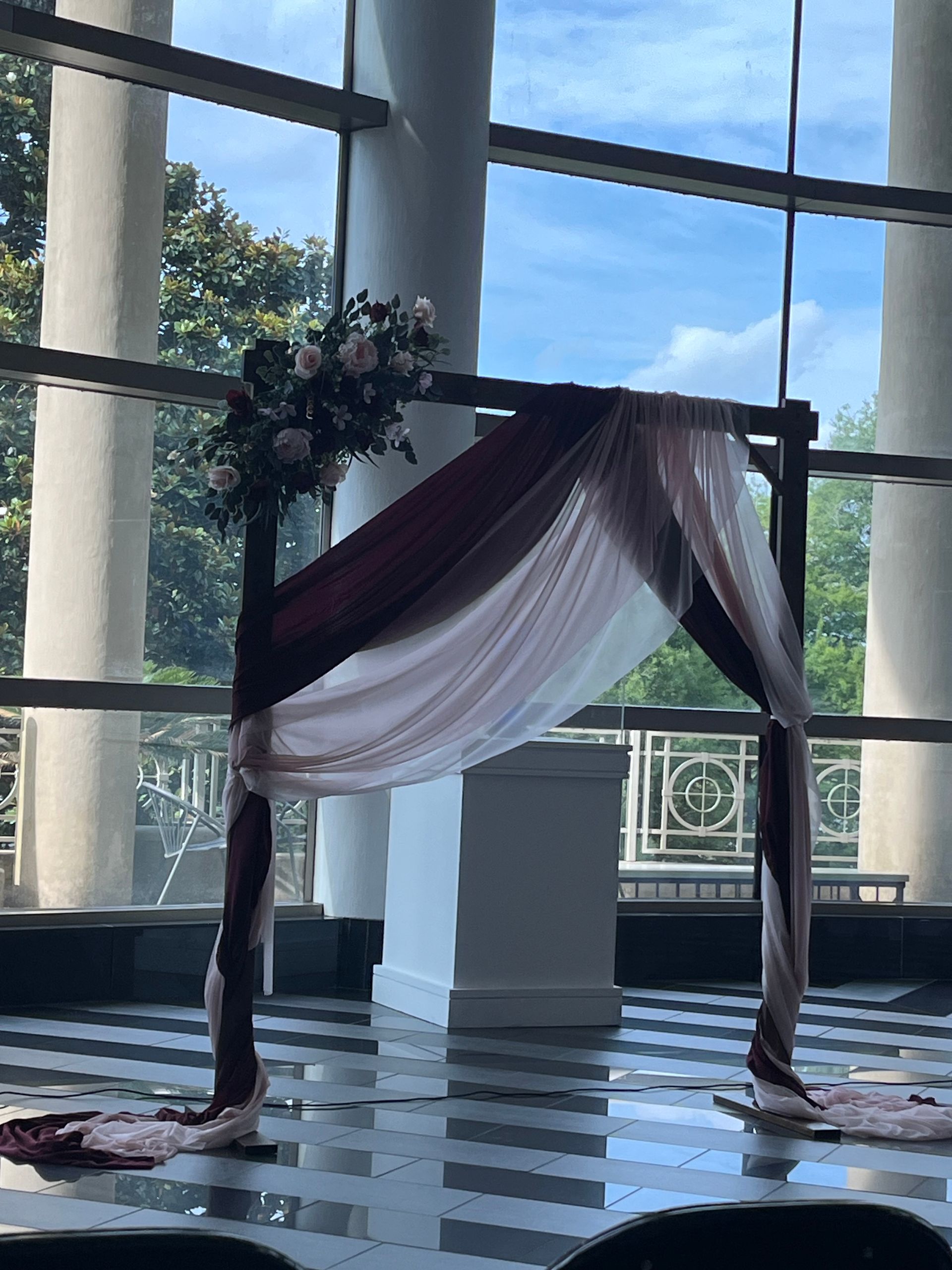 A large window with a purple and white arch in front of it