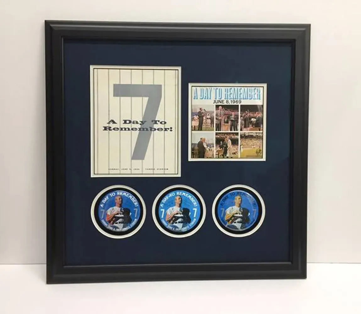 Framed sports memorabilia: Poster and pins set against a navy blue mat, in a black frame.