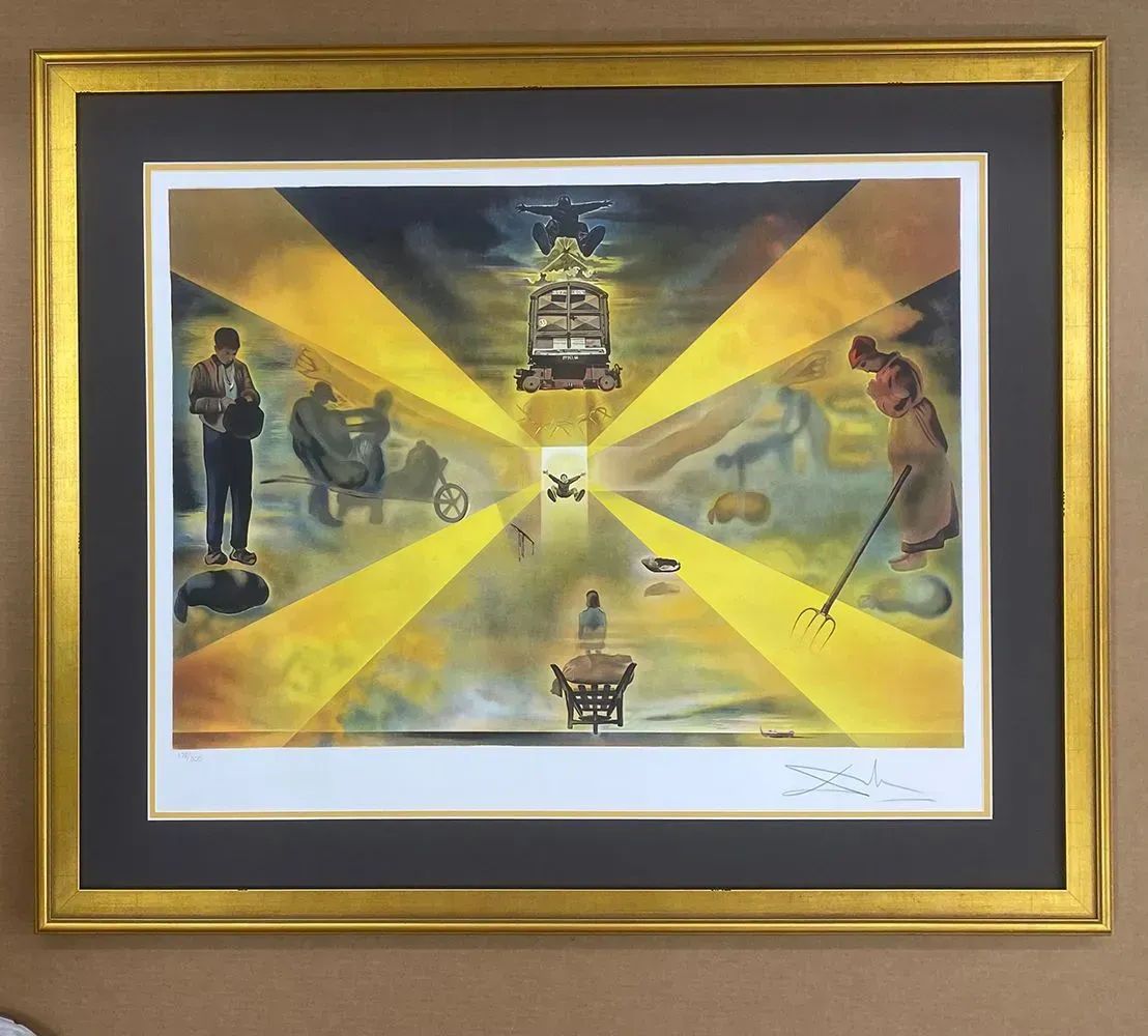 Dalí surrealist art print in a gold frame. Figures in a radiating yellow light.