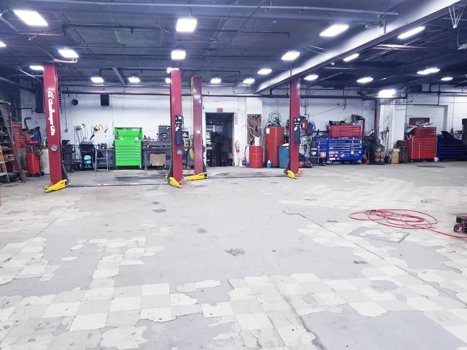 A large empty garage with two lifts in it