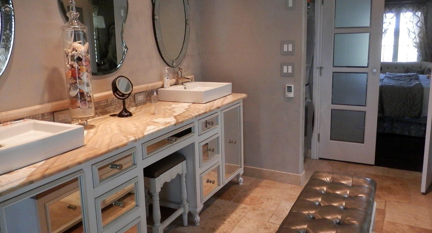 bathroom with marbled sink countertop