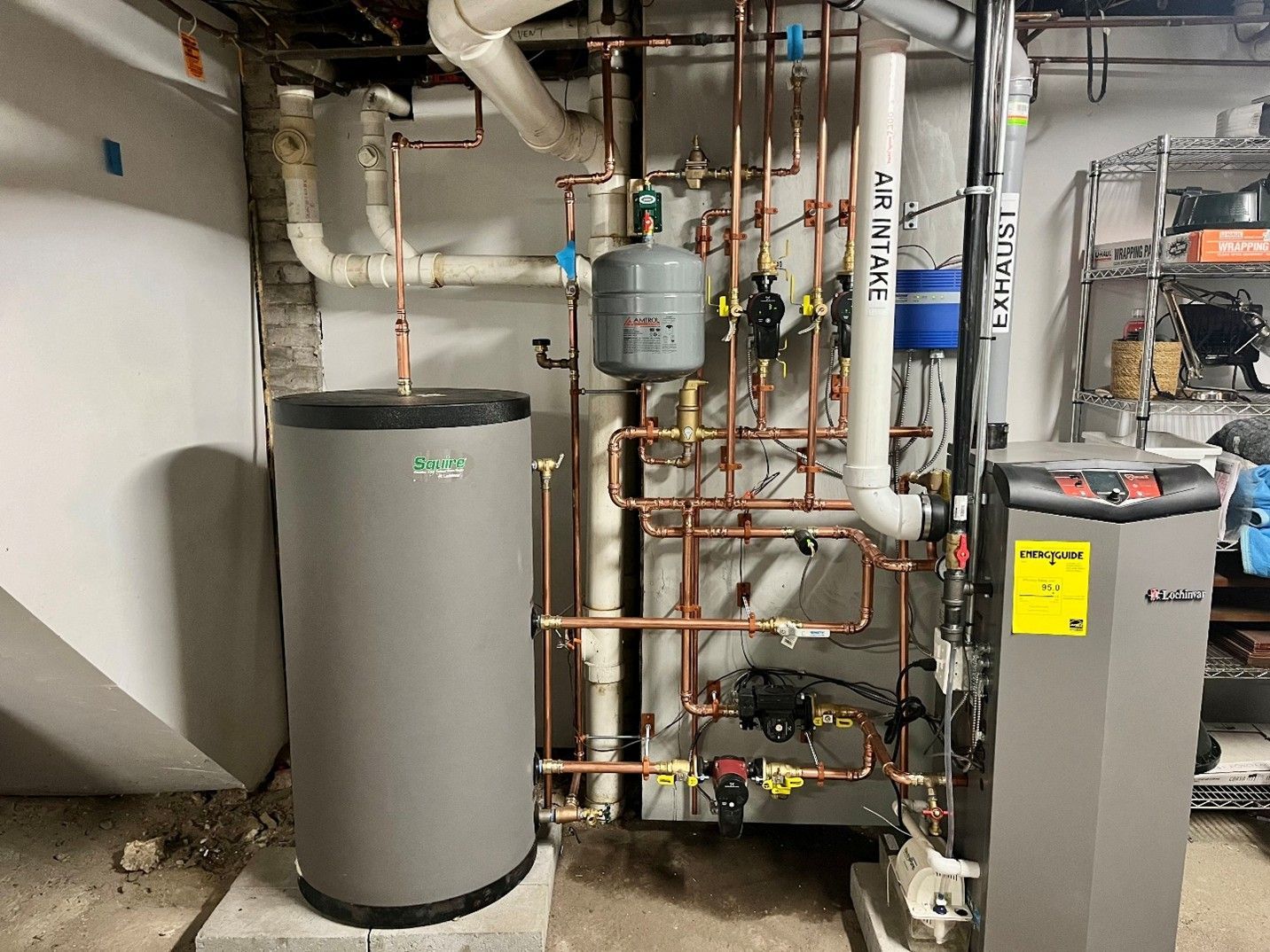 Water heater and furnace, copper pipes, and related equipment in a basement setting.