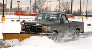 truck clearing snow on a parking lot