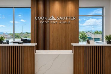 Office reception desk with wood slats and city view through windows