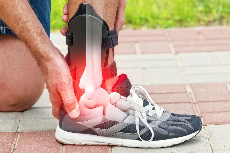 Person holding a runner’s ankle with a red glow indicating pain or injury