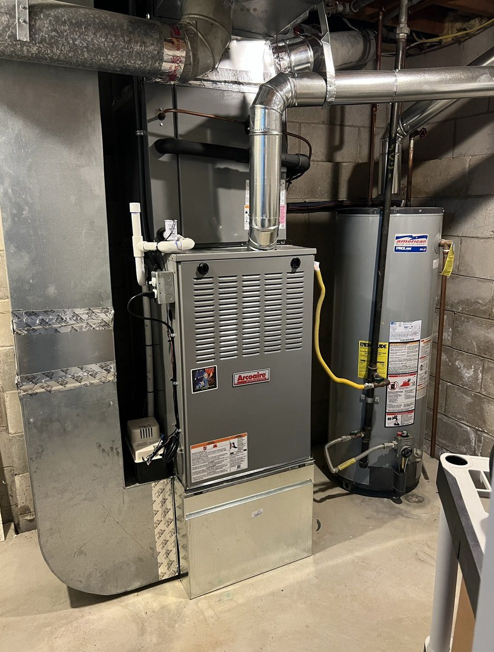 There is a water heater and a furnace in the basement.