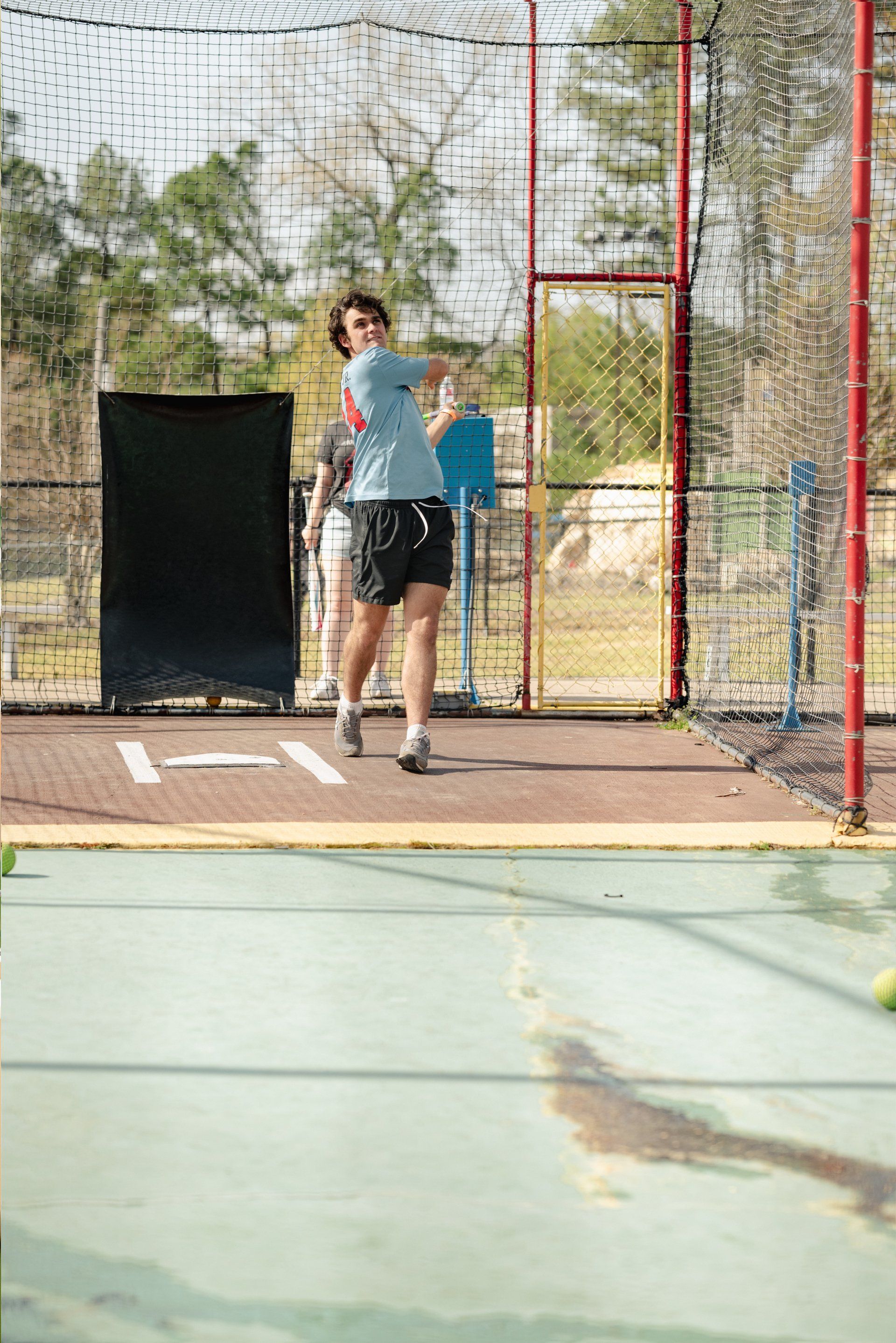 Teen Guy Batting Cage with Blue Shirt