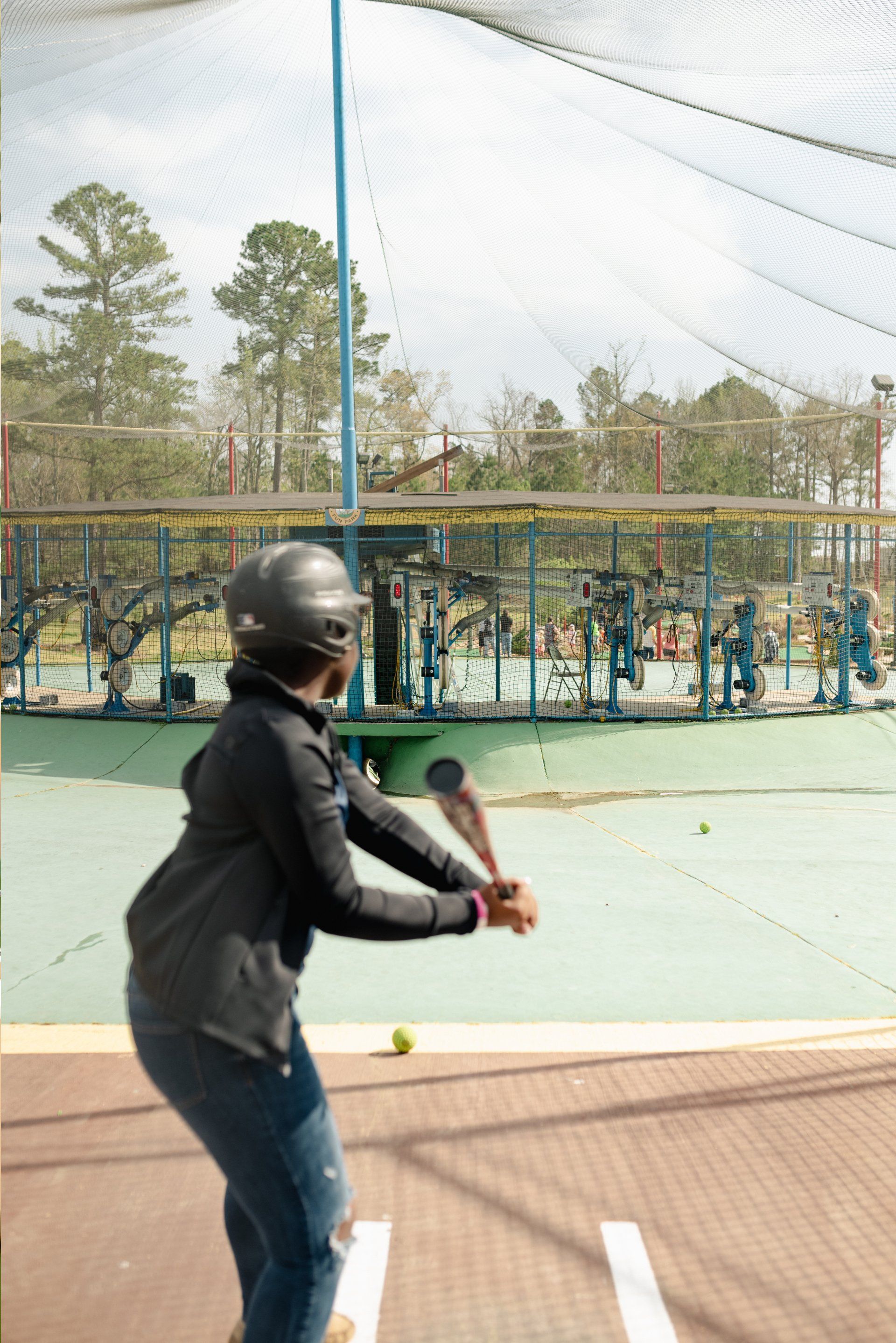 Teen with Black Hoodie Batting Cage