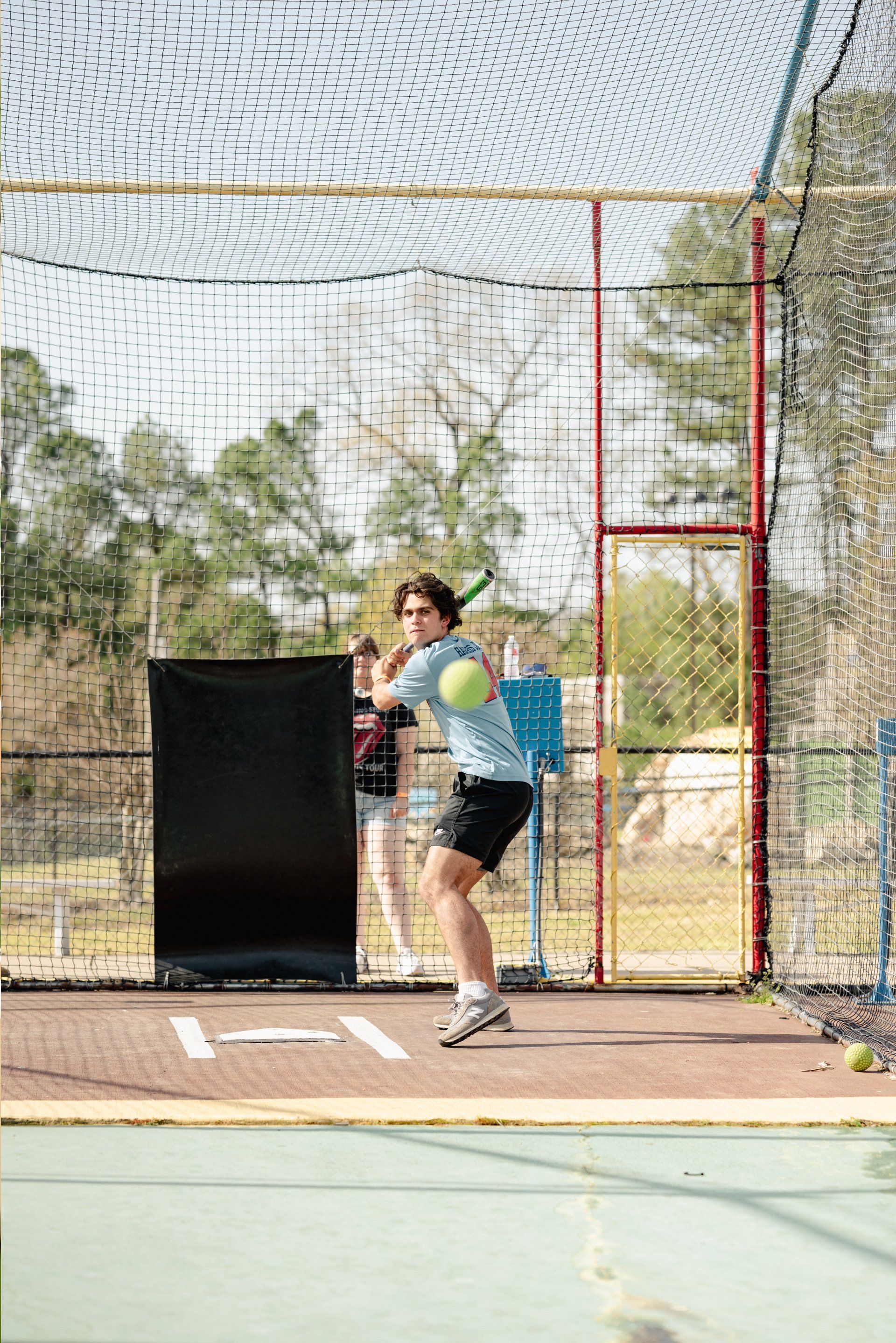 Teen Guy Batting Cage with Blue Shirt