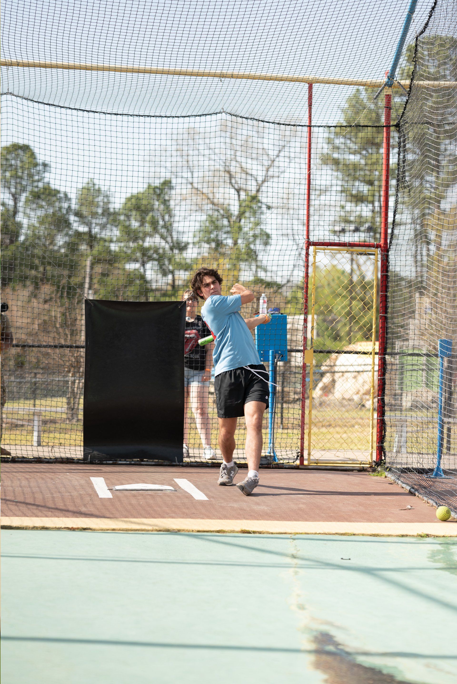 Teen Guy Batting Cage with Blue Shirt