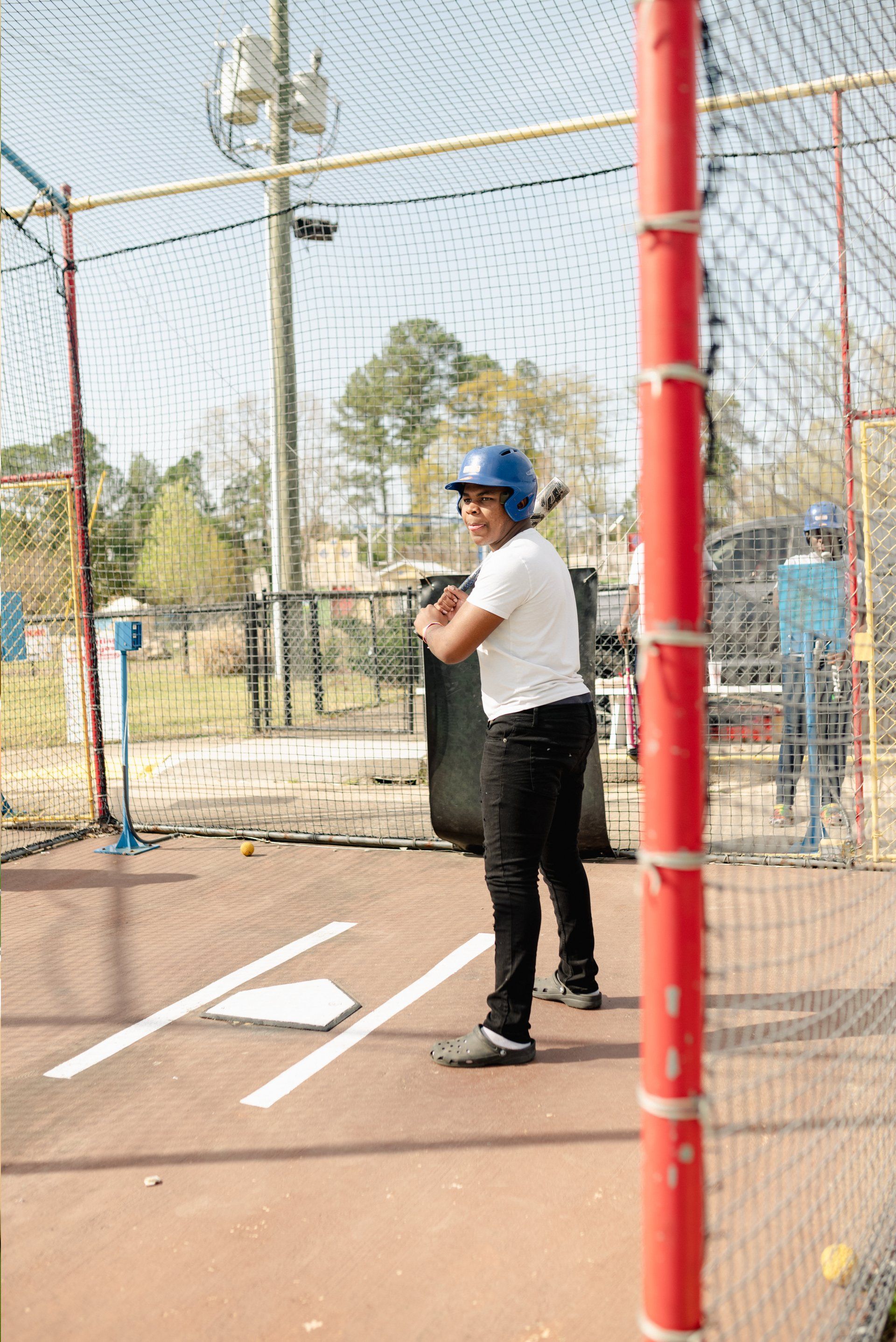 Kid with White Shirt Batting Cage