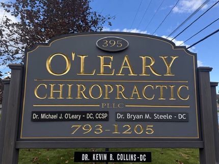 O'Leary Chiropractic sign with gold lettering and phone number 793-1205 on a roadside monument sign