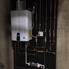 Wall-mounted boiler with copper pipes and gauges in a utility room