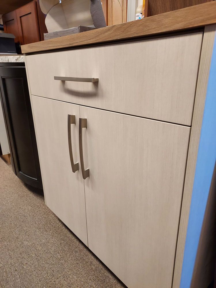 A cabinet with two doors and a drawer in a kitchen