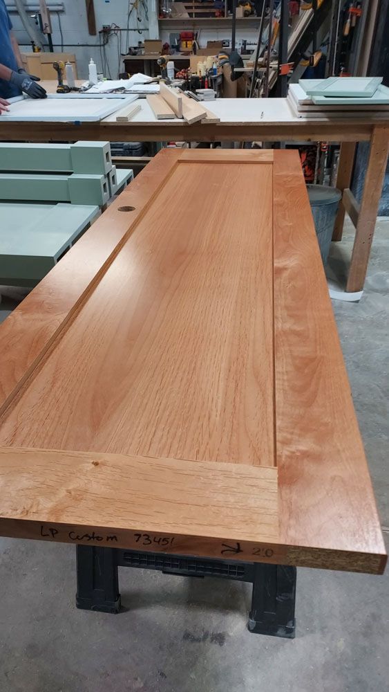 A large piece of wood is sitting on top of a table in a workshop