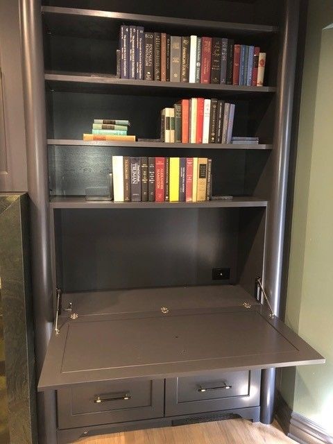 A bookshelf with a desk underneath it