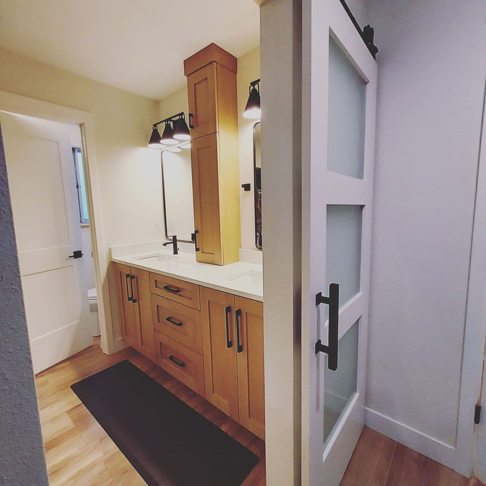 A bathroom with two sinks and a sliding glass door
