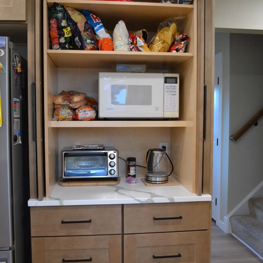 A kitchen with a microwave oven and a toaster oven