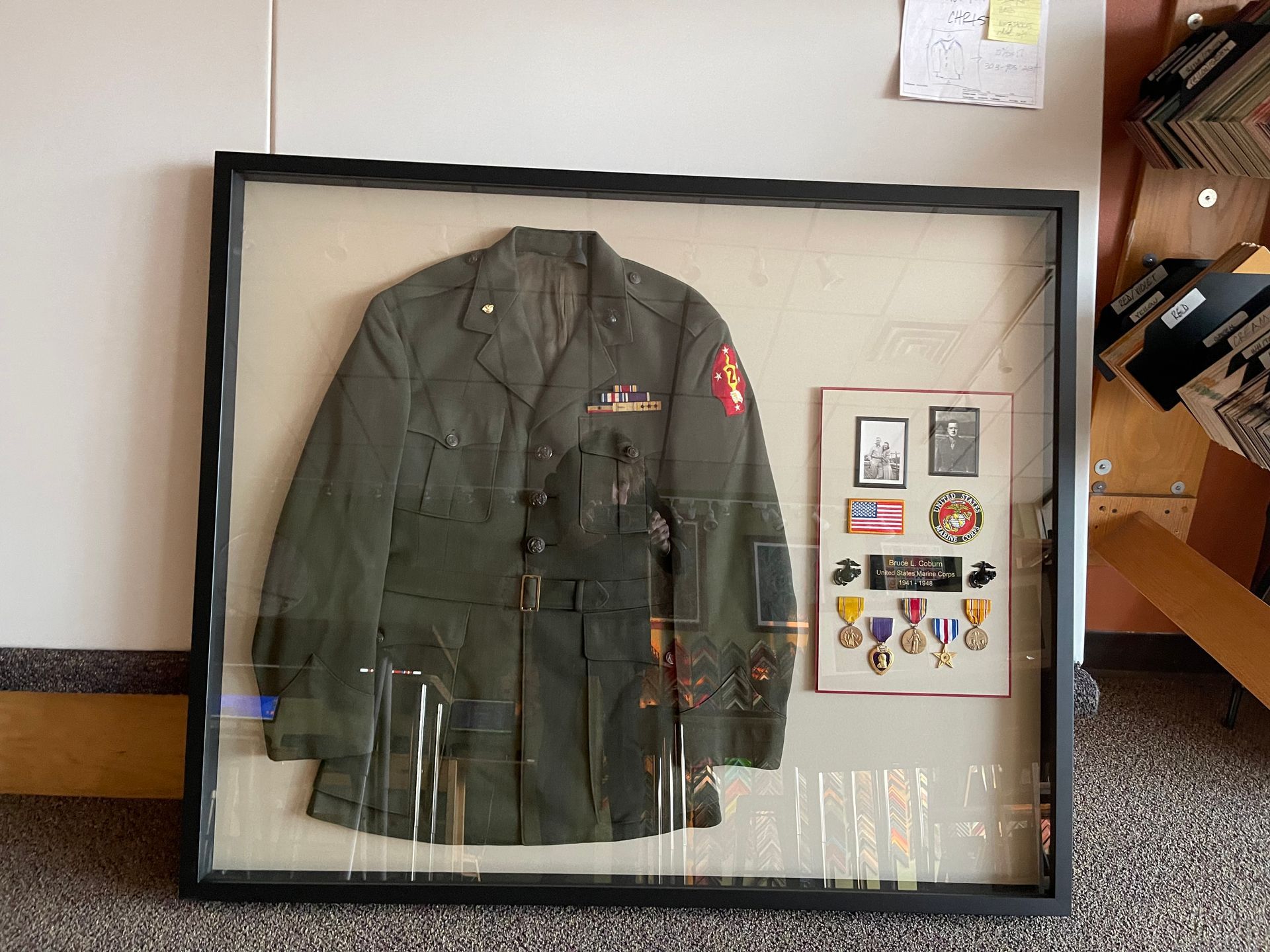 A framed military jacket with medals on it