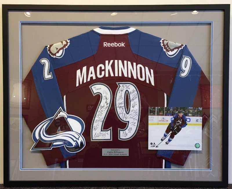 A framed jersey with the name mackinnon on it