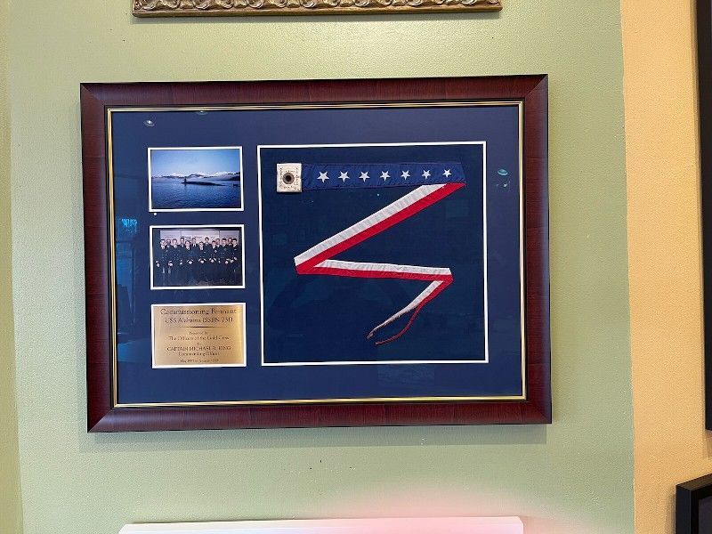 A framed picture of an american flag on a wall