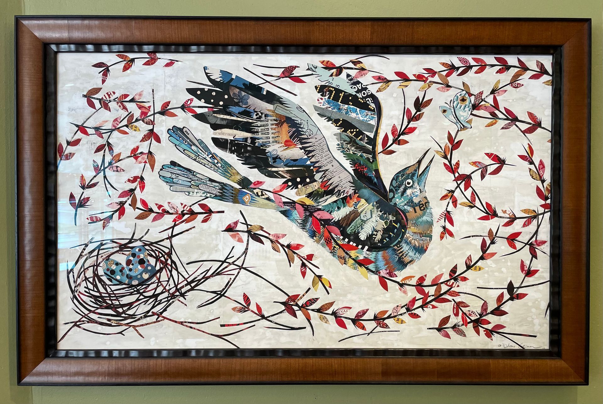 A framed painting of a bird flying over a nest