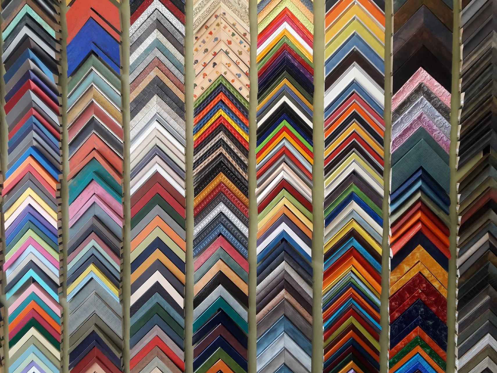 A variety of picture frames are lined up in a row