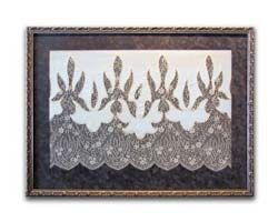 A picture of a lace border in a frame on a white background.