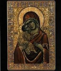 A religious icon of the Virgin Mary holding the Child Jesus, featuring a gold background with detailed, stylized framing.