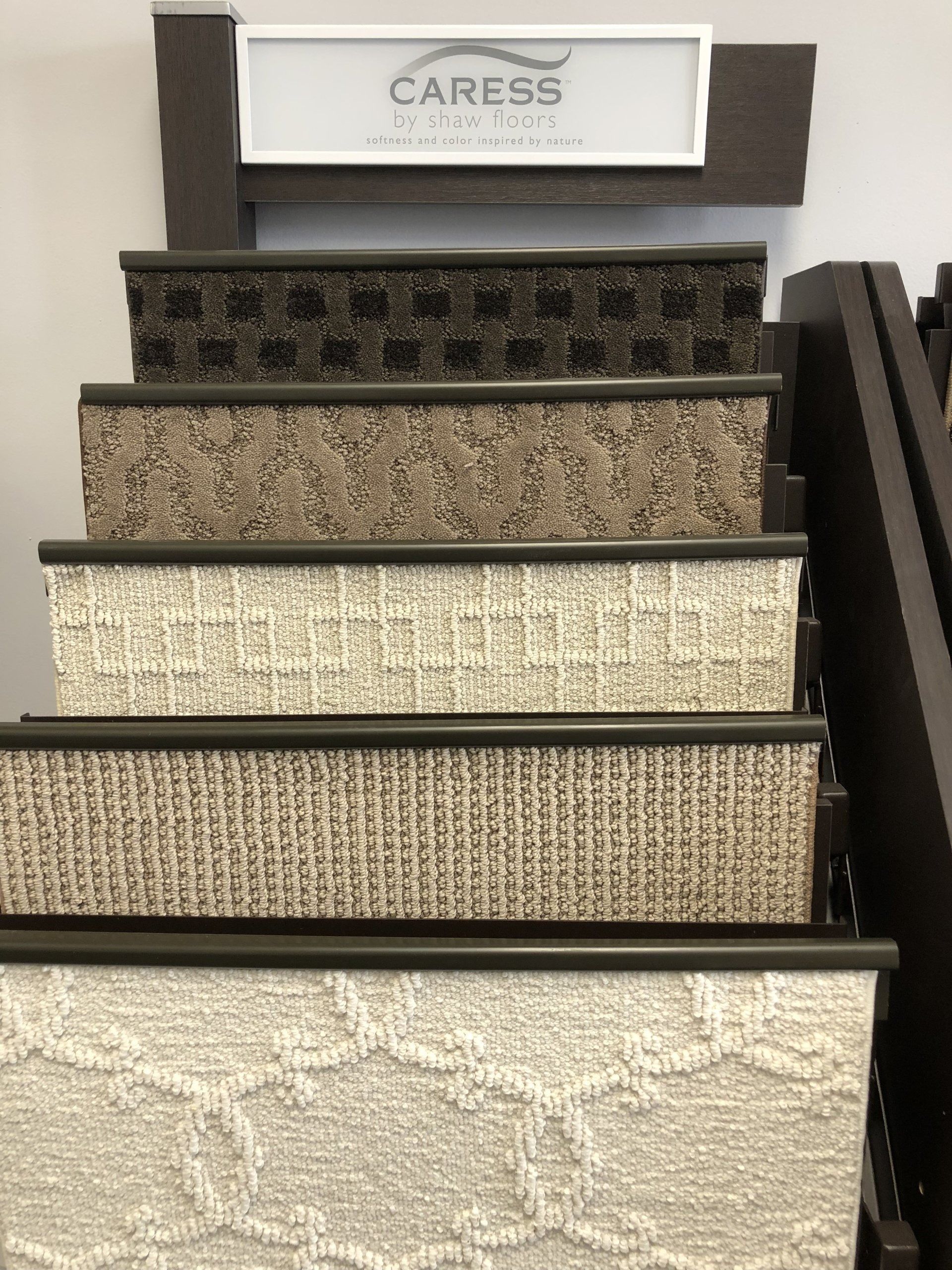A display of caress carpets in a store