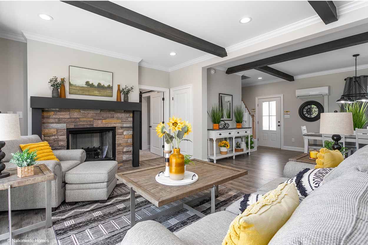 A living room with a couch, chair, coffee table, and fireplace.