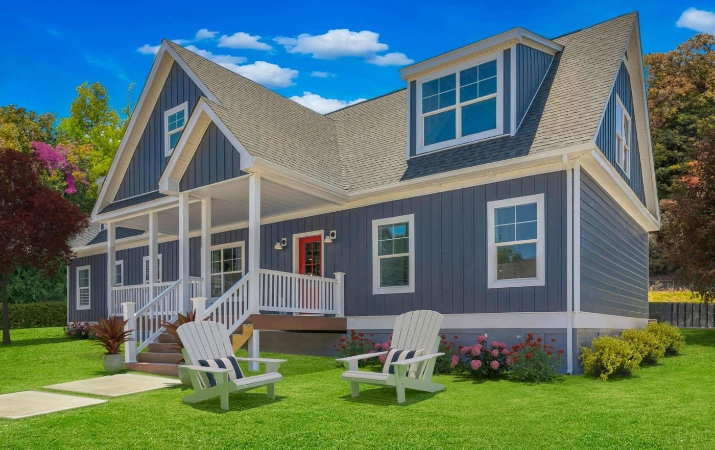 A large house with a porch and chairs in front of it.