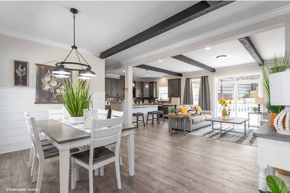 There is a dining table and chairs in the middle of the room.