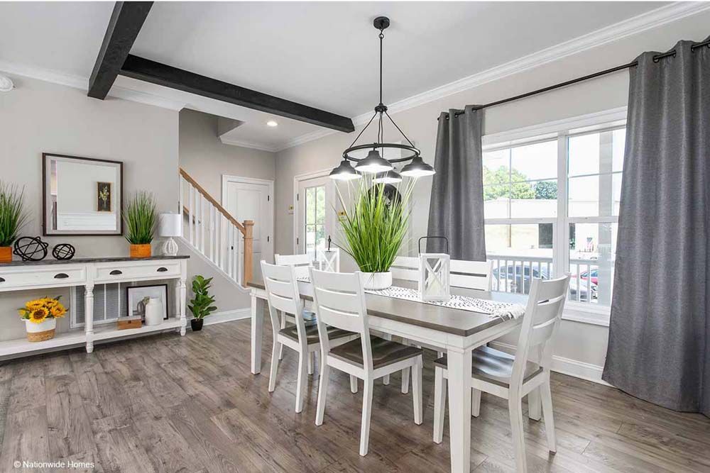 A dining room with a table and chairs and a chandelier.