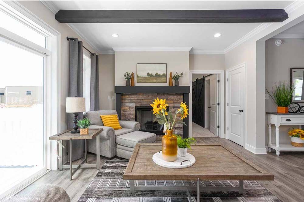 A living room with a fireplace and a coffee table.