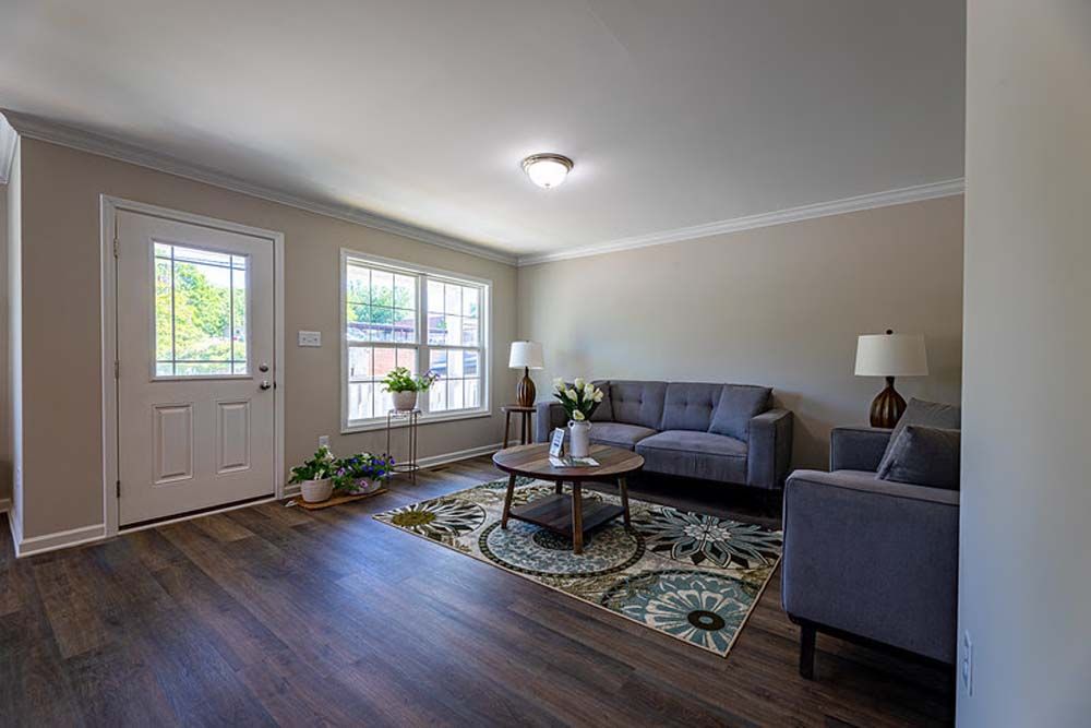 A living room with a couch, chairs, and a coffee table.