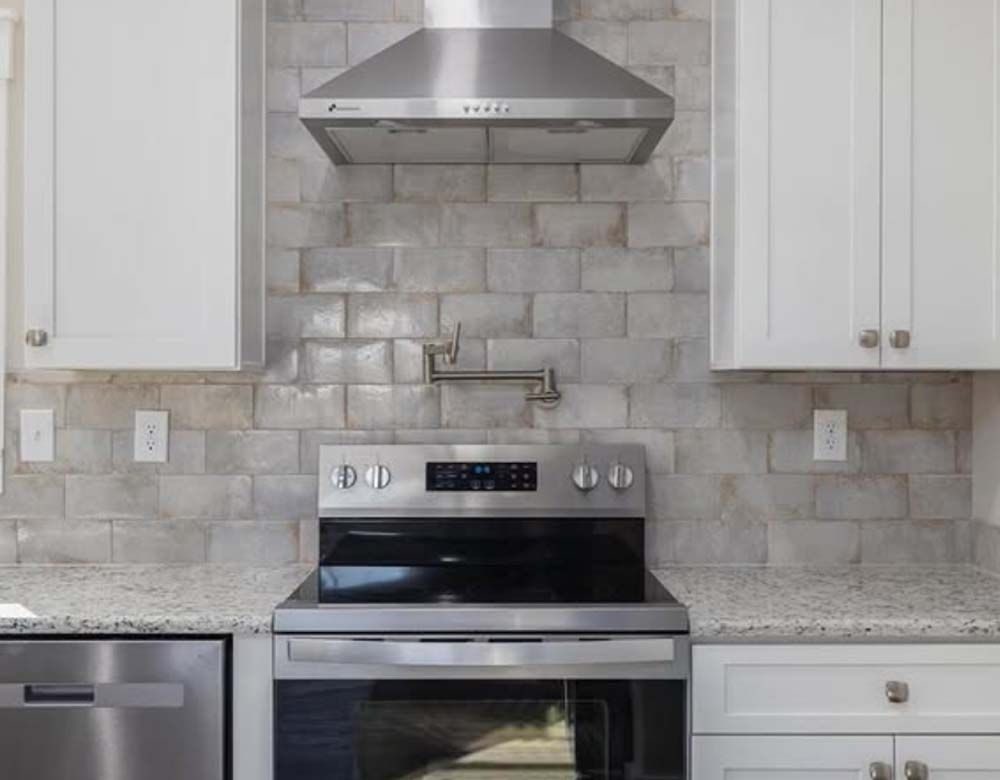 A kitchen with a stove, oven, and dishwasher.
