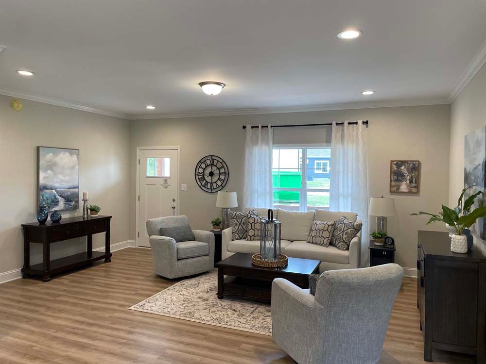 A living room with a couch, chairs, and a coffee table.
