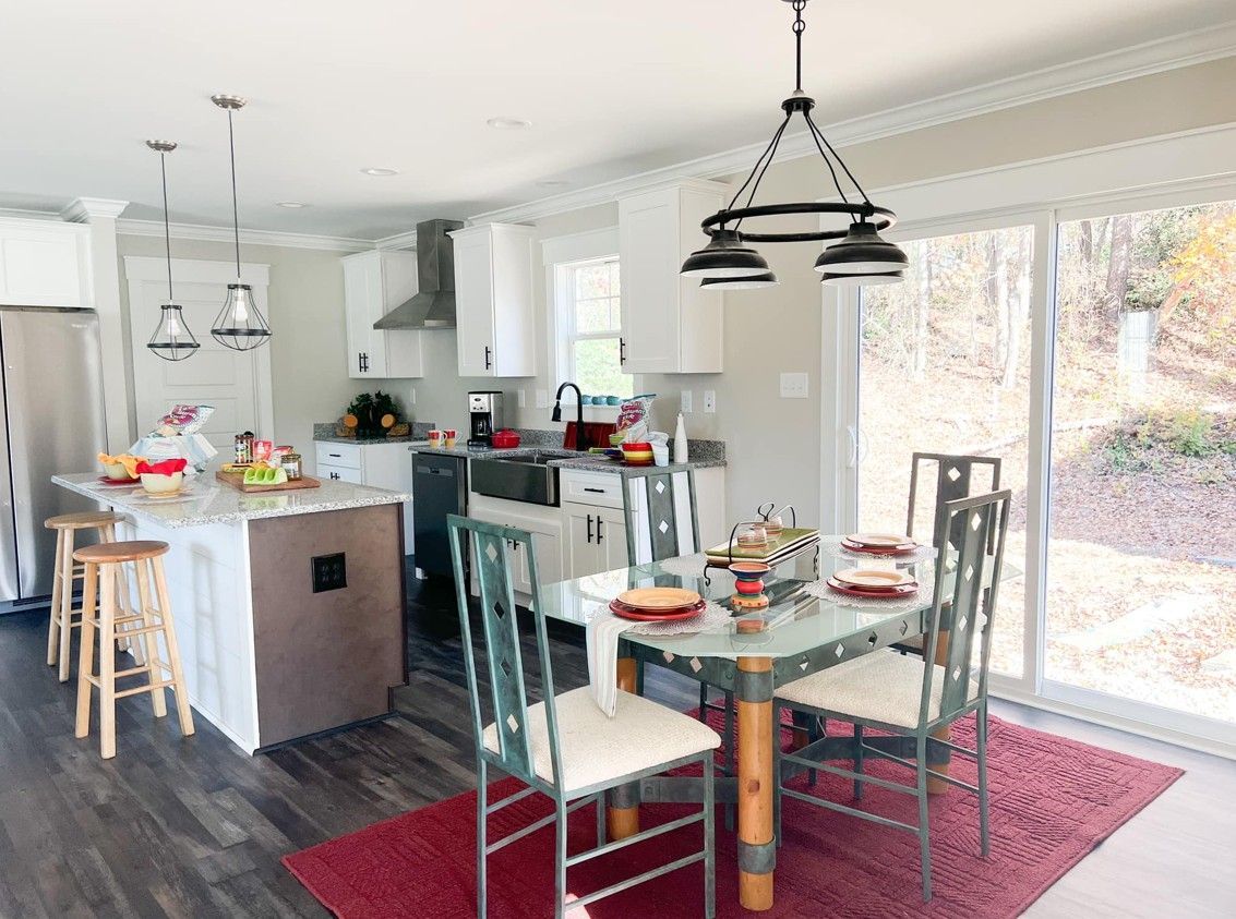 A black and white photo of a kitchen and dining room.
