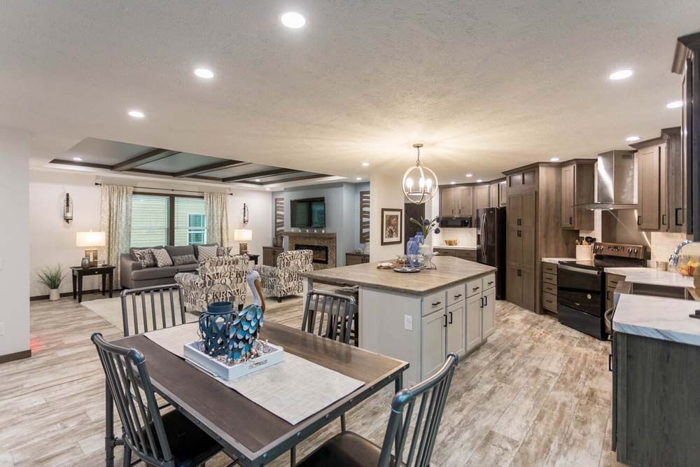 There is a dining table and chairs in the middle of the room.