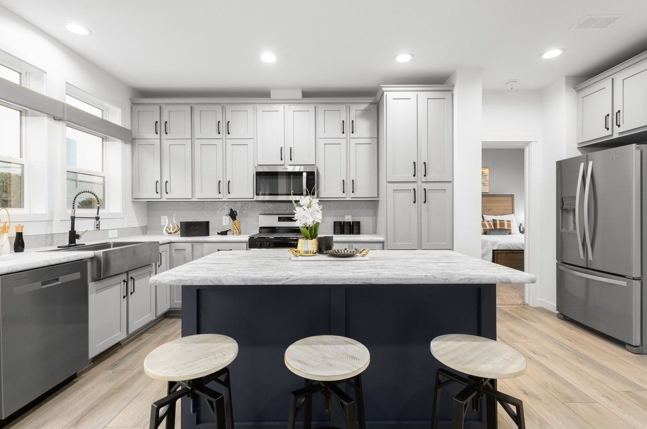A black and white photo of a kitchen with stainless steel appliances.