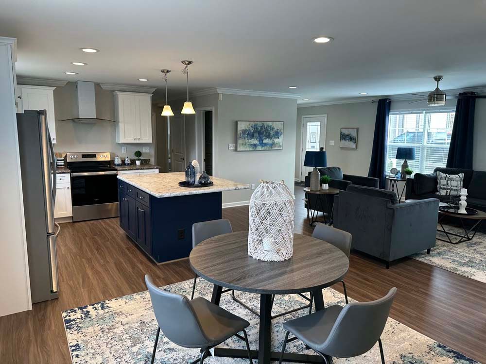 There is a table and chairs in the middle of the room.