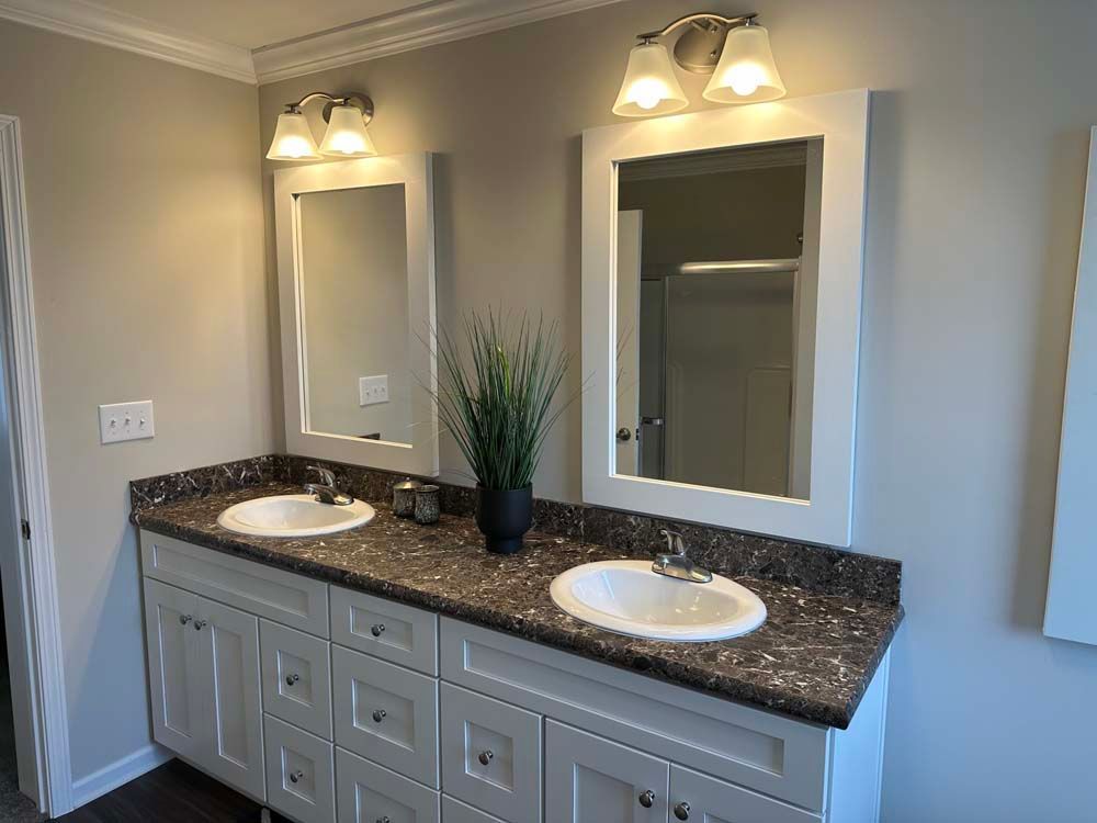 A bathroom with two sinks and two mirrors.