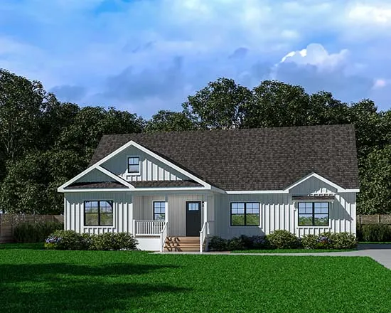 A white house with a black roof is sitting on top of a lush green lawn.